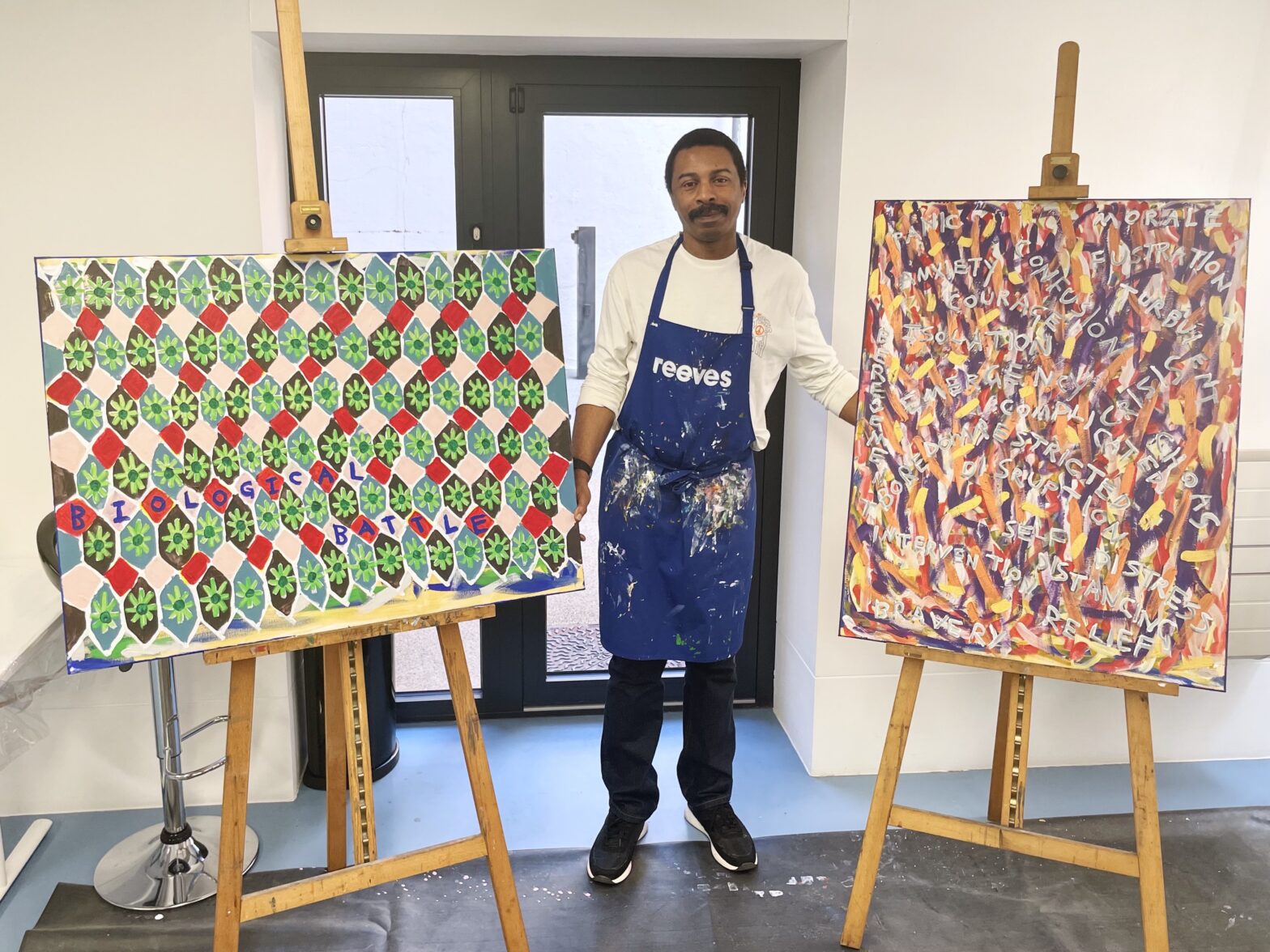 Artist Thompson Hall with two of his artworks