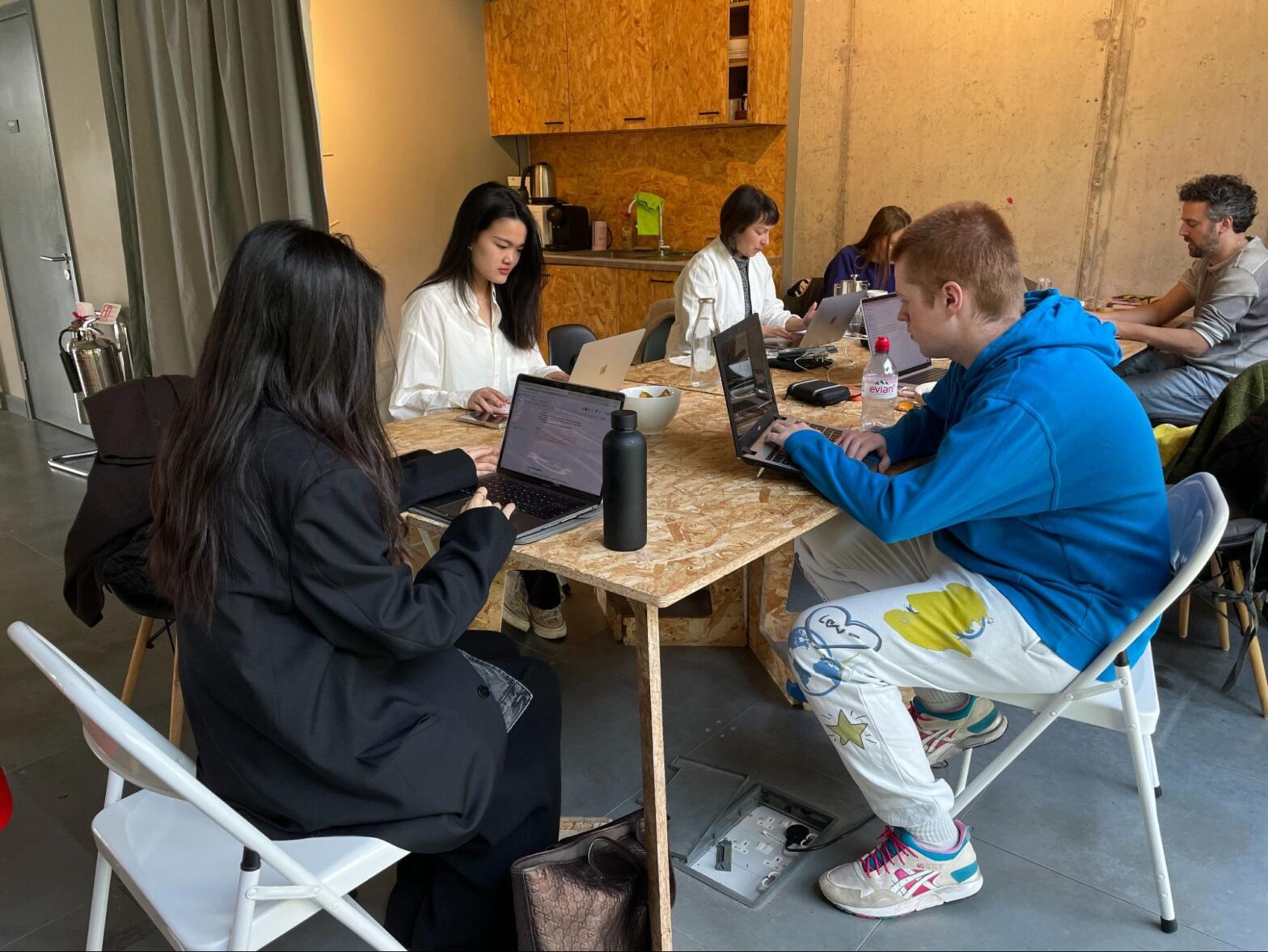 A group of students working together at a communal desk
